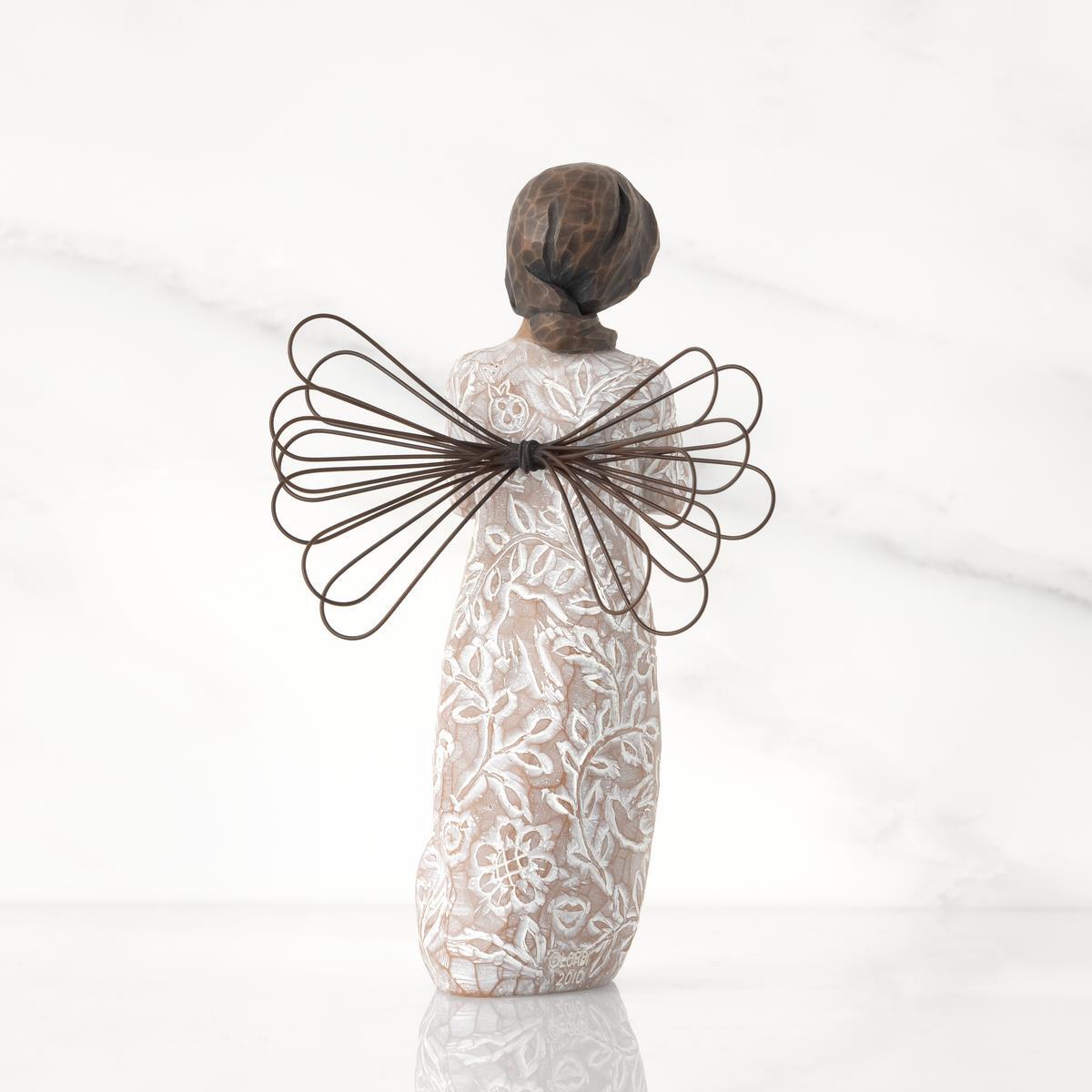 Back_view_of_Willow_Tree_Remembrance_Angel_darker_skin_figurine_holding_a_gold_heart