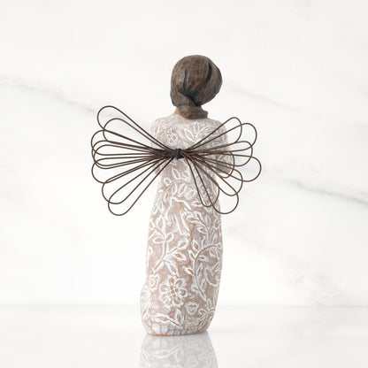 Back_view_of_Willow_Tree_Remembrance_Angel_darker_skin_figurine_holding_a_gold_heart