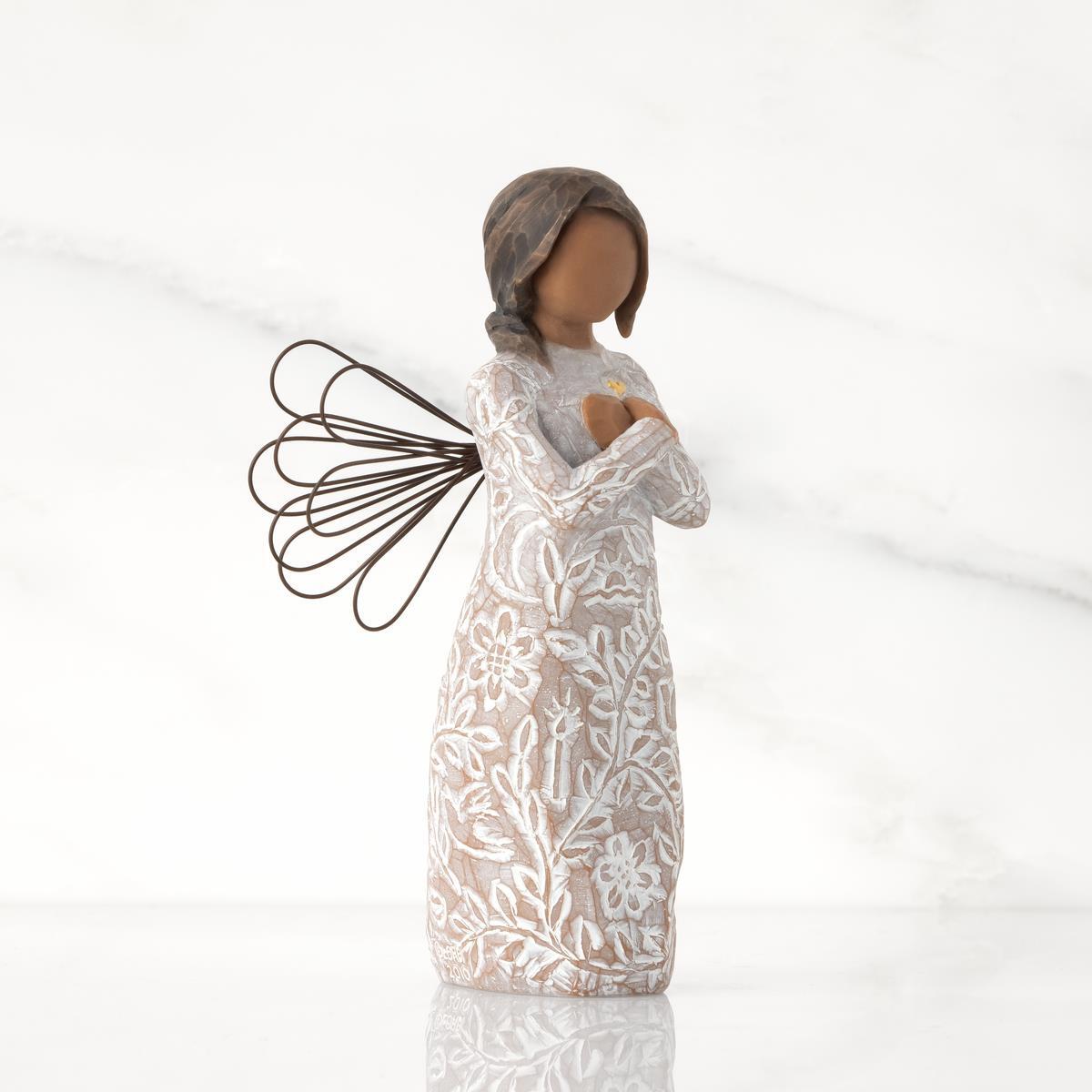 Side_view_of_Willow_Tree_Remembrance_Angel_darker_skin_figurine_holding_a_gold_heart