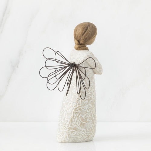 Back view of Willow Tree Remembrance Angel figurine holding a gold heart